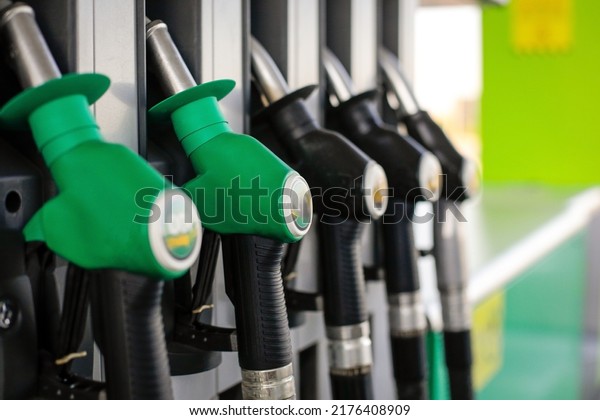 Shallow depth of field (selective focus) details\
with fuel pumps at a gas\
station.