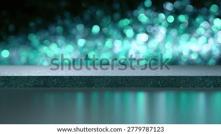 A shallow depth of field shot featuring out-of-focus teal bokeh lights in the background and a dark, reflective surface in the foreground.
