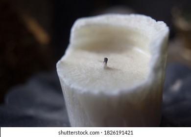 Shallow Depth Of Field With Thin Focus On Partially Burned Organic Soy Scented Decorative Candle Sitting On A Dark Metal Tray To Catch Melted Wax Drippings And Protect Furniture In Antique Home