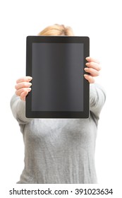 Shallow DOF Photo Of Tablet In Hands Of Foxy Girl, Face Is Hidden Behind Tablet, Girl Show Screen To Camera. Isolated On White