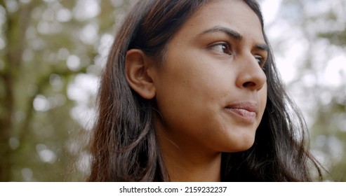 A Shallow Focus Of A Beautiful Indian Woman Against Trees At A Park