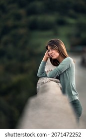 A Shallow focus of a caucasian model posing in the park on a blurred background