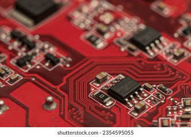 Shallow focus close-up shot of electronic circuit board components in red. Perfect for backgrounds on technology-related topics. Depending on our experiences and ideas, we can interpret many meaning.