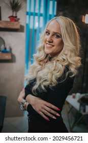 A Shallow Focus Closeup Shot Of A Young Woman Posing Outdoors In A Black Dress