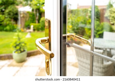 Shallow focus of the keyhole seen on a newly fitted double glazed generic door. Leading to a patio area and enclosed garden.
