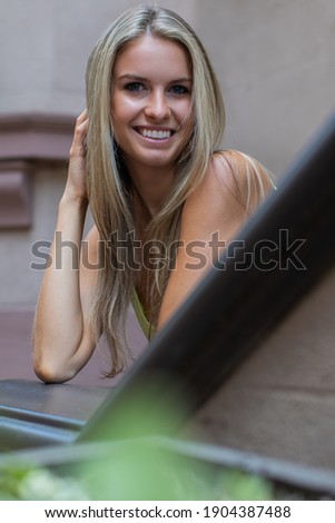 Similar – Happy young woman with moving hair in urban background