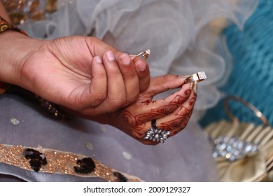 A Shallow Focus Of Male Hand And Female Hand Holding Engaging Rings During Rings Ceremony In India ,henna Hand Tattoo