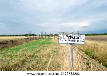 Shallow focus of a No Public Right of Way sign seen on farm land. Located near a public footpath, to help stop stray walkers accessing pricing farm land.
