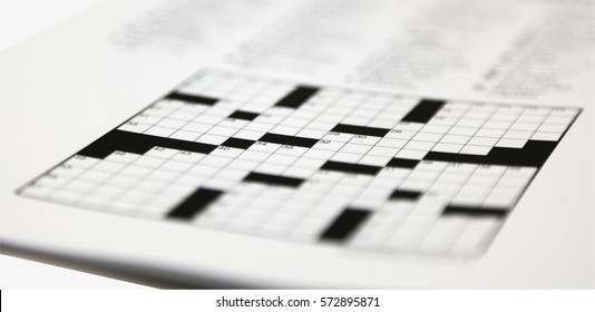 Shallow Focus On Daily Newspaper Crossword Puzzle.