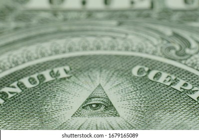 Shallow focus on the Eye of Providence on the reverse of the US one dollar bill.