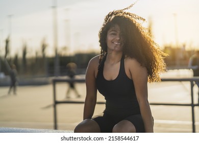 A Shallow Focus Shot Of A Beautiful Curly Woman Smiling