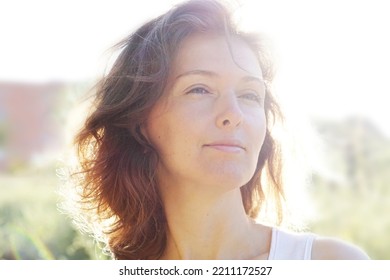 A Shallow Focus Shot Of A Caucasian Short-haired And Middle-aged Woman In The Field