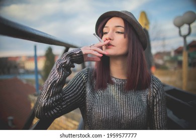 A Shallow Focus Shot Of A Caucasian Woman Smoking Outside