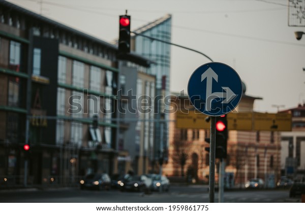 A\
shallow focus shot of a go straight or right road\
sign