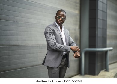 A shallow focus shot of a handsome confident African male in a suit and sunglasses