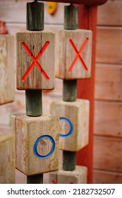 A Shallow Focus Shot Of A Tic Tac Toe Game With Wooden Blocks Of X's And O's At The Playground