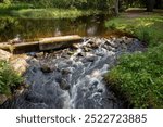 Shallow stream in sunny public park, Oulu Finland