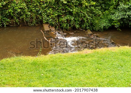  Shallow stream and weir in a park
