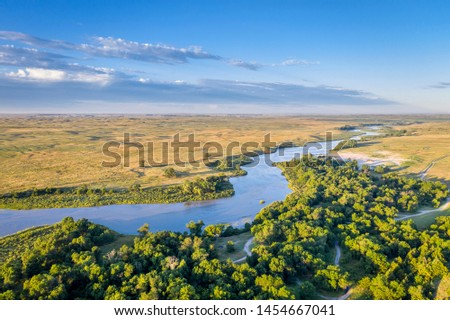 shallow and wide Dismal RIver meandering trough Nebraska Sandhills at Nebraska National Forest, aerial view of summer scenery