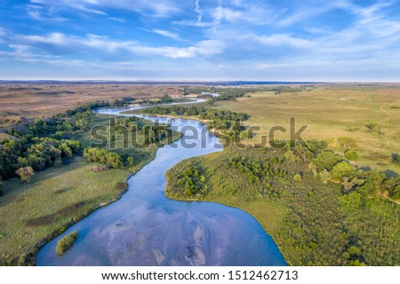 shallow and wide Dismal River meandering trough Nebraska Sandhills at Nebraska National Forest, aerial view of late summer or early fall scenery