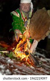 The Shaman Performs The Ritual At Night By The Fire With A Tambourine. Shamanism And Ethnoculture Of The Peoples Of Mountain Shoria And Altai. The Real Moment Of The Sorcerer's Work With Spirits