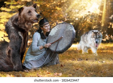 Shaman woman playing her shaman sacred drum in the forest among wild animals - a dog and a bear. Ethnic traditions