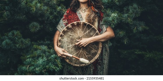 shamanic girl playing on shaman frame drum in the nature. - Shutterstock ID 2155935481