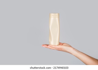 Shampoo Bottle In Hand. Gel Dispenser For Hair Care. Container With Body Lotion. Female Hands With Cosmetic Bottle. Hands Holding Bottle Of Hair Conditioner. Female Hand With Cosmetics Bottles.