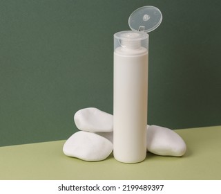 Shampoo Bottle With Pebbles On A Green Two Tone Background. Aesthetic Beauty Still Life