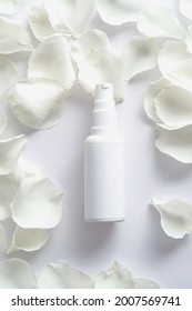 Shampoo Pump Bottle And Rose Petals On White Background. Flat Lay, Top View