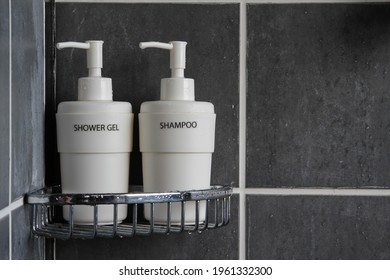 Shampoo And Shower Gel Bottles On The Wall Shelf In The Hotel Bathroom.