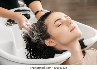 Shampooing. Closeup Shot Of A Beautiful Woman At The Hair Salon