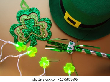 Shamrock Lights With A Leprechaun Hat A Shamrock Or Clover. Also A Party Blower
On A Gold Background Top View.