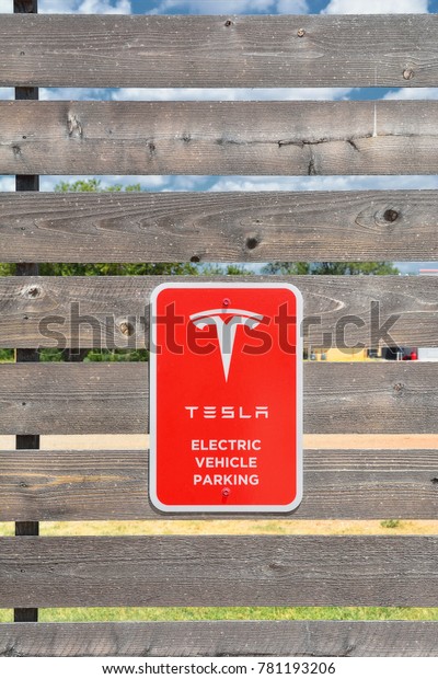 Shamrock, Texas - July 20, 2017: Tesla\
Supercharger Station in Shamrock, Texas. Tesla motors develops\
network of the charging stations across\
World.