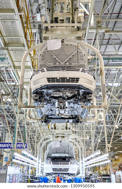 Shanghai, Asia, China - January 12,\
2016: Volkswagen car hangs on the assembly line for automatic\
installation at Volkswagen\'s automobile factory in\
Shanghai.