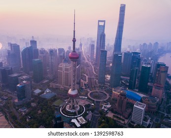 Shanghai, China - 05/09/2019 : Aerial View Of Skyscraper And High-rise Office Buildings In Downtown With Fog. Financial District And Business Centers In Smart City In Asia At Sunrise.