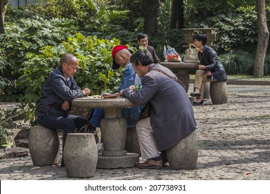 SHANGHAI, CHINA - 28th MARCH 2014: Peoples Square Where People Meet To Talk And Play Board Games In The Park Every Morning