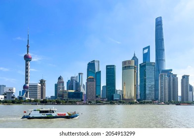 Shanghai, China - 2nd October 2021 - View Of The Shanghai Lujiazui City Skyline Featuring The Oriental Pearl TV Tower And Shanghai Tower, With Boat Crossing The Huangpu River 