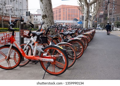 Shanghai, China – 3/24/2019: A large amount of sharing-bike (rental bikes) docked alongside the street. Sharing-bike is phenomenon and was created by the Chinese technology companies.