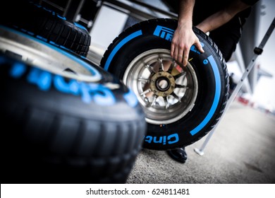 Shanghai, China - April 6-9, 2017: Wet Pirelli tires and hand racing mechanic at Formula One Chinese Grand Prix at Shanghai Circuit.
