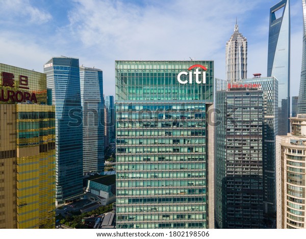 Shanghai, China - Aug 2, 2020: Aerial view of\
Citibank building in downtown Lujiazui Financial District. With\
landmark skyscrapers around. Citibank was founded in 1812 as the\
City Bank New York
