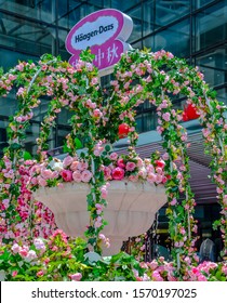 Shanghai, China, August 5, 2016 Häagen-Dazs Ice Cream Logo Under Pink Roses Arrangement