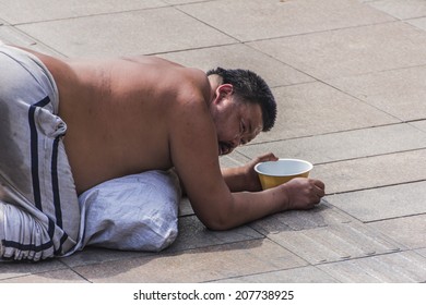 SHANGHAI, CHINA - CIRCA MARCH 2014:There Are Beggars Strategically Positioned All Around The Peoples Park In Shanghai