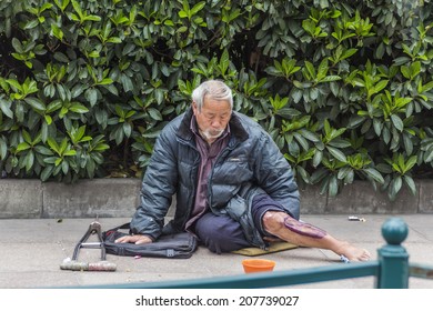 SHANGHAI, CHINA - CIRCA MARCH 2014:There Are Beggars Strategically Positioned All Around The Peoples Park In Shanghai