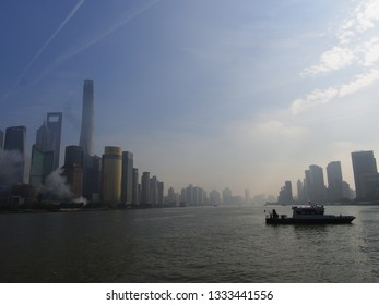 Shanghai/ China - December 3rd 2018: A Police Boat On The Huang Pu River With The Iconic Shanghai Skyline Of Lu Jia Zui In The Background Taken From The Bund On A Hazy Day With Poor Air Quality