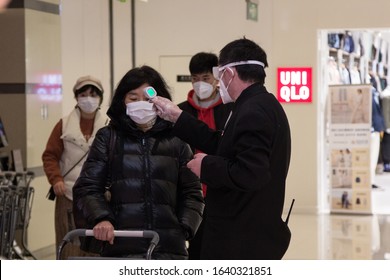Shanghai, China - February 10 2020: Checking Temperature On Entrance To The Supermarket. Novel Corona Virus Made People To Put Masks Everywhere.