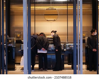 Shanghai China Jan 8 2022 People And Shop Assistant In The Gold Store. Commercial Business Finance And Gold Concept Photo. People Wearing Mask During Coronavirus Pandemic Period.