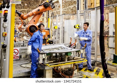 Shanghai, China, China - January 12, 2016: Workers Are Installing Car Window Glass In The Shanghai Volkswagen Factory Assembly Line