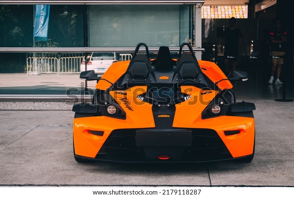 Shanghai, China- July 16,2022: An orange KTM\
X-BOW roadster is parked in\
courtyard