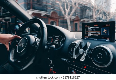 Shanghai, China- July 8,2022: The Hand Of A Driver Is Holding The Steering Wheel Of A Blue Audi S3 Sedan